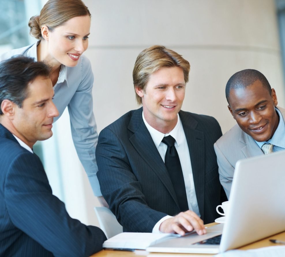Business people working together and using a laptop